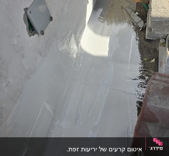 איטום קיר עם חומר לבן וכלי עבודה מסביב